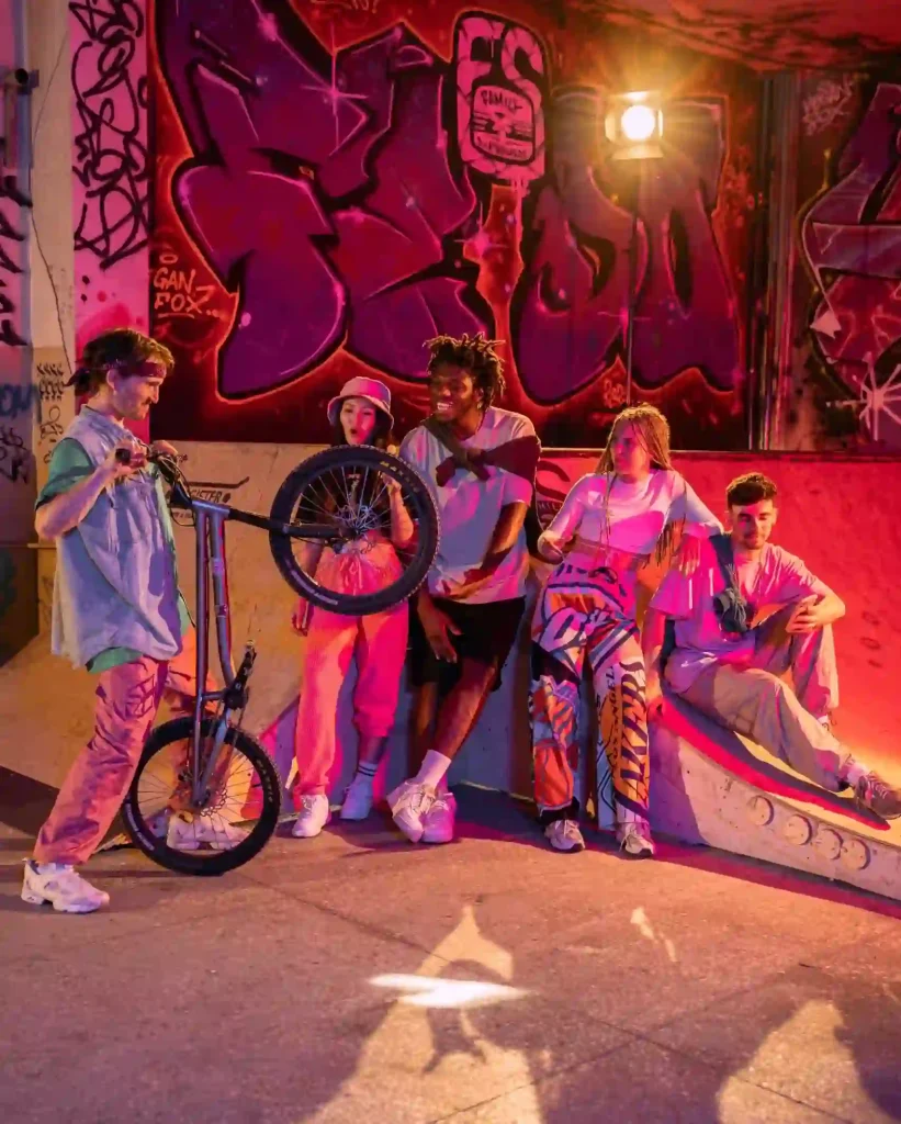 a group of people standing next to a ramp with a bike